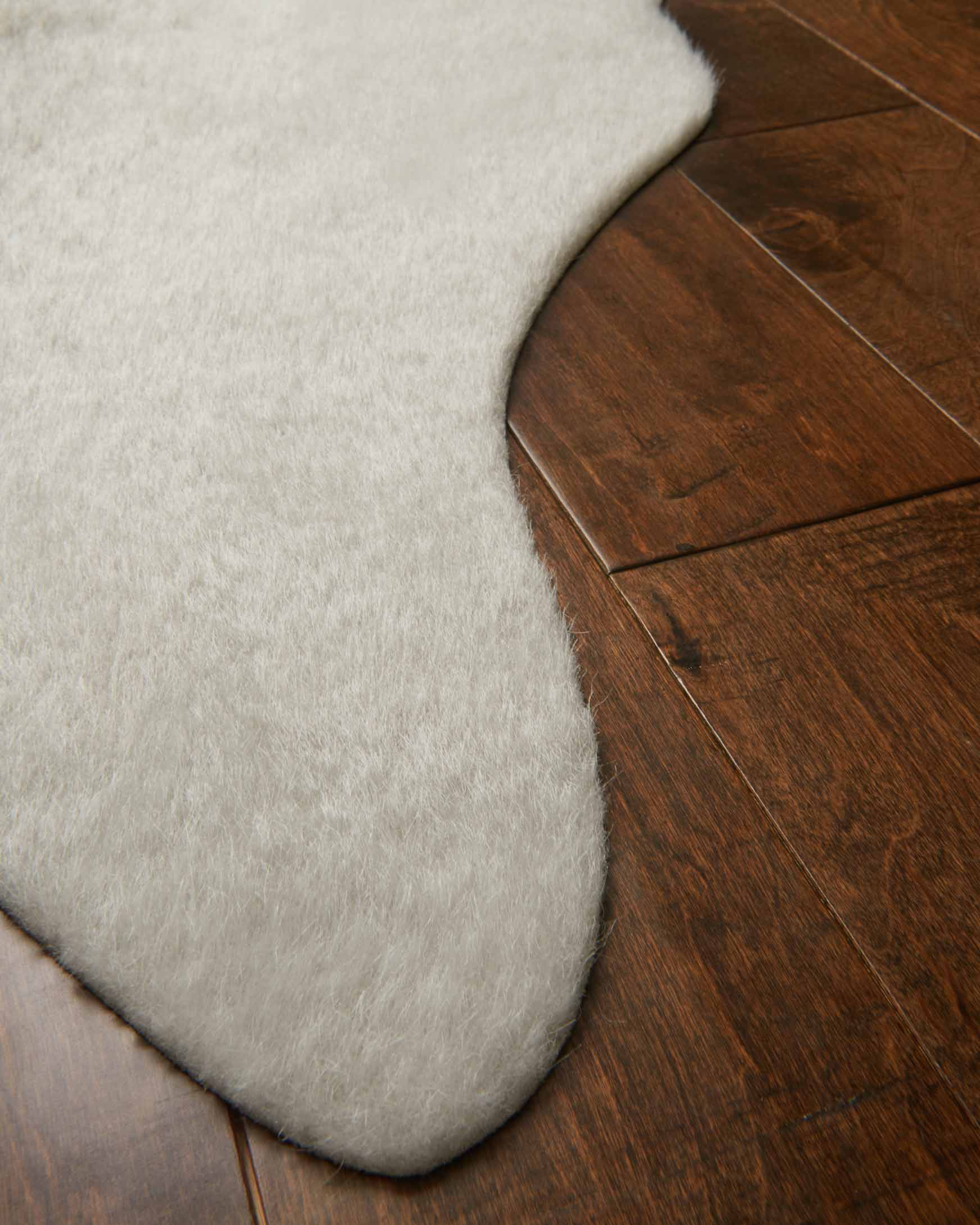 Silver grey rug corner detail with short dense pile and rounded scalloped edge
