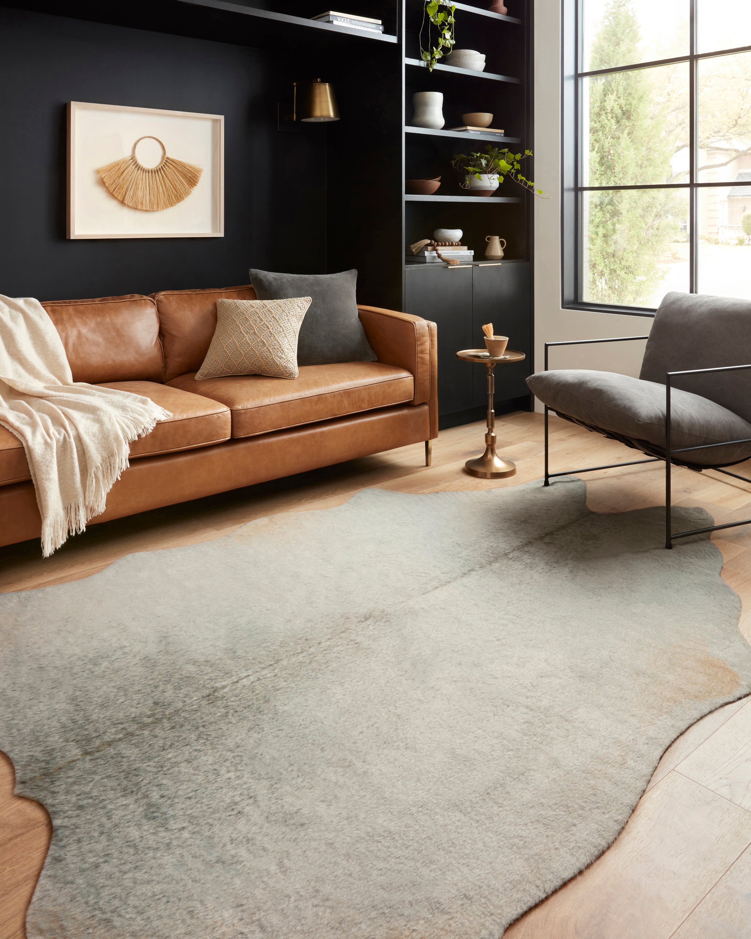 Grey mottled area rug with soft pile and irregular edge shape