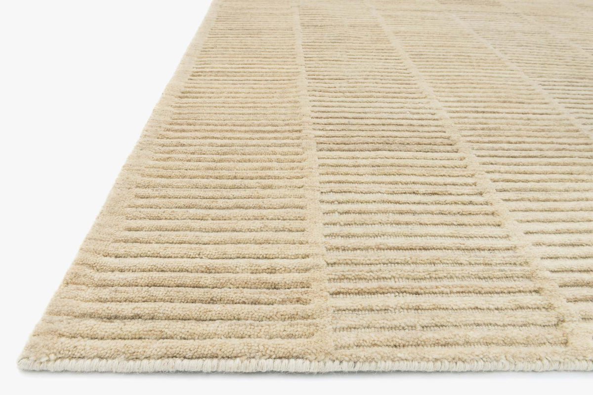 Natural hand-loomed rug corner with striped weave texture and finished edge