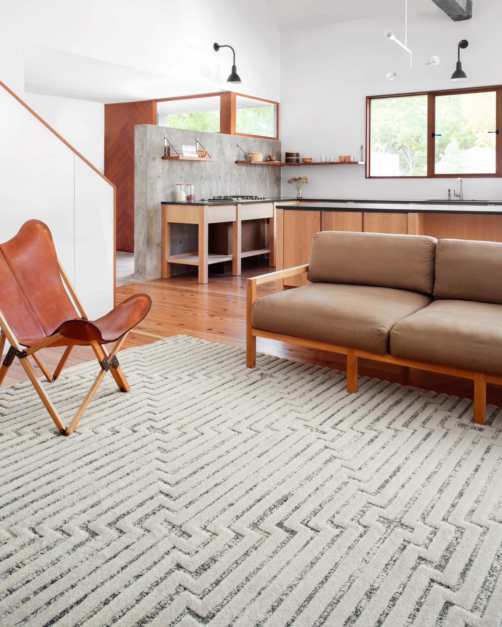 White rug with woven zigzag border and repeating geometric cross motifs