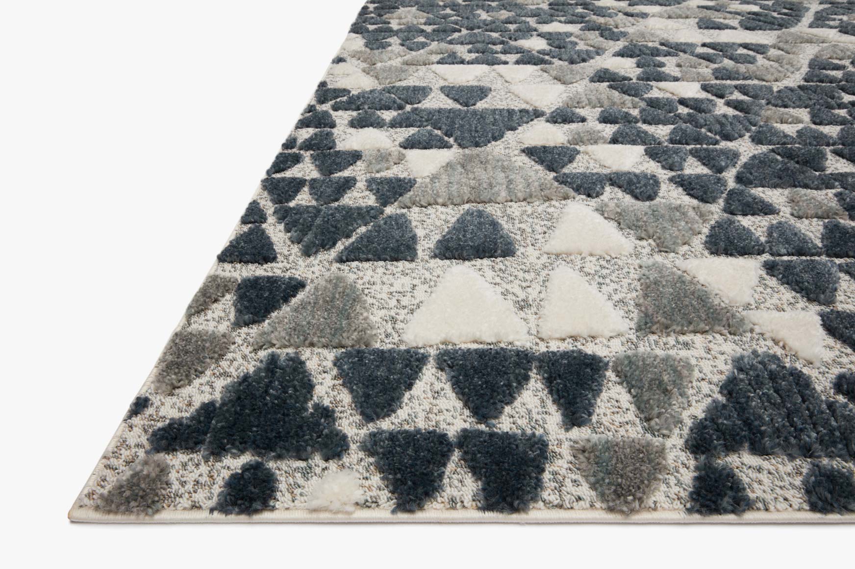 Rectangular slate and denim rug with repeating geometric triangle pattern