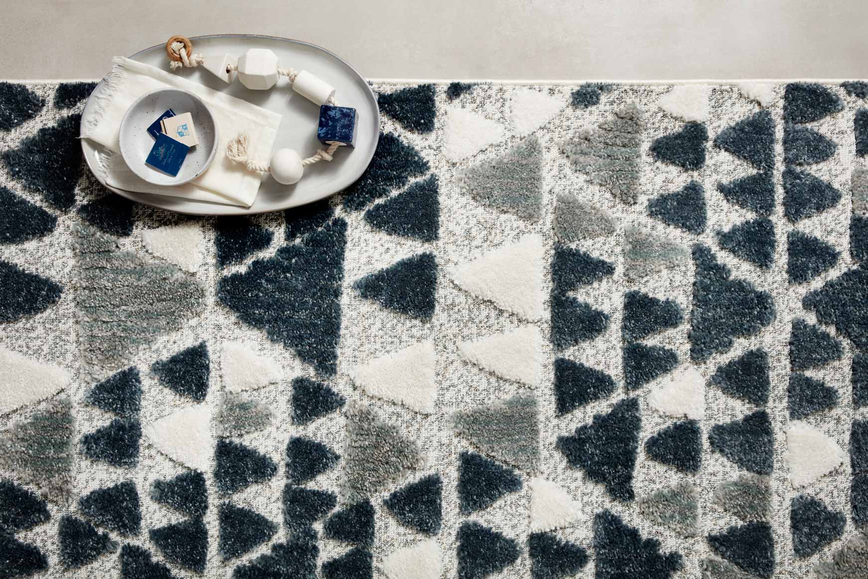 Close-up of slate and cream triangle pattern rug with short pile texture