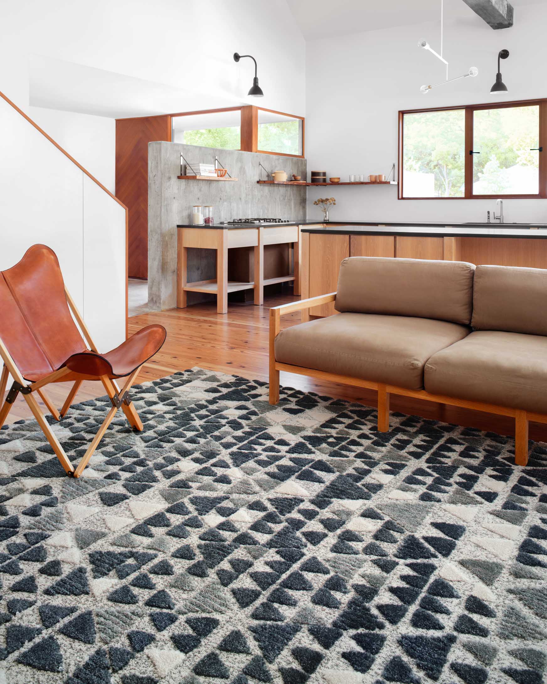 Slate and denim triangle patterned rug in a living room layout