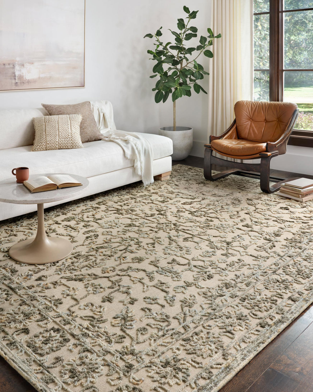 Traditional hooked rug on floor with distressed grey and sky motif