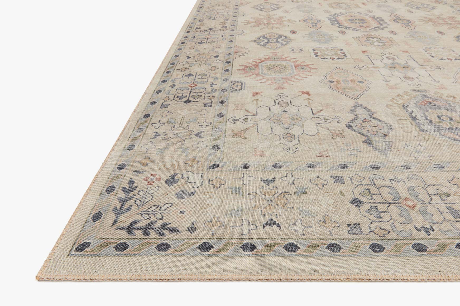 Close-up of beige traditional rug edge with multicolor geometric pattern