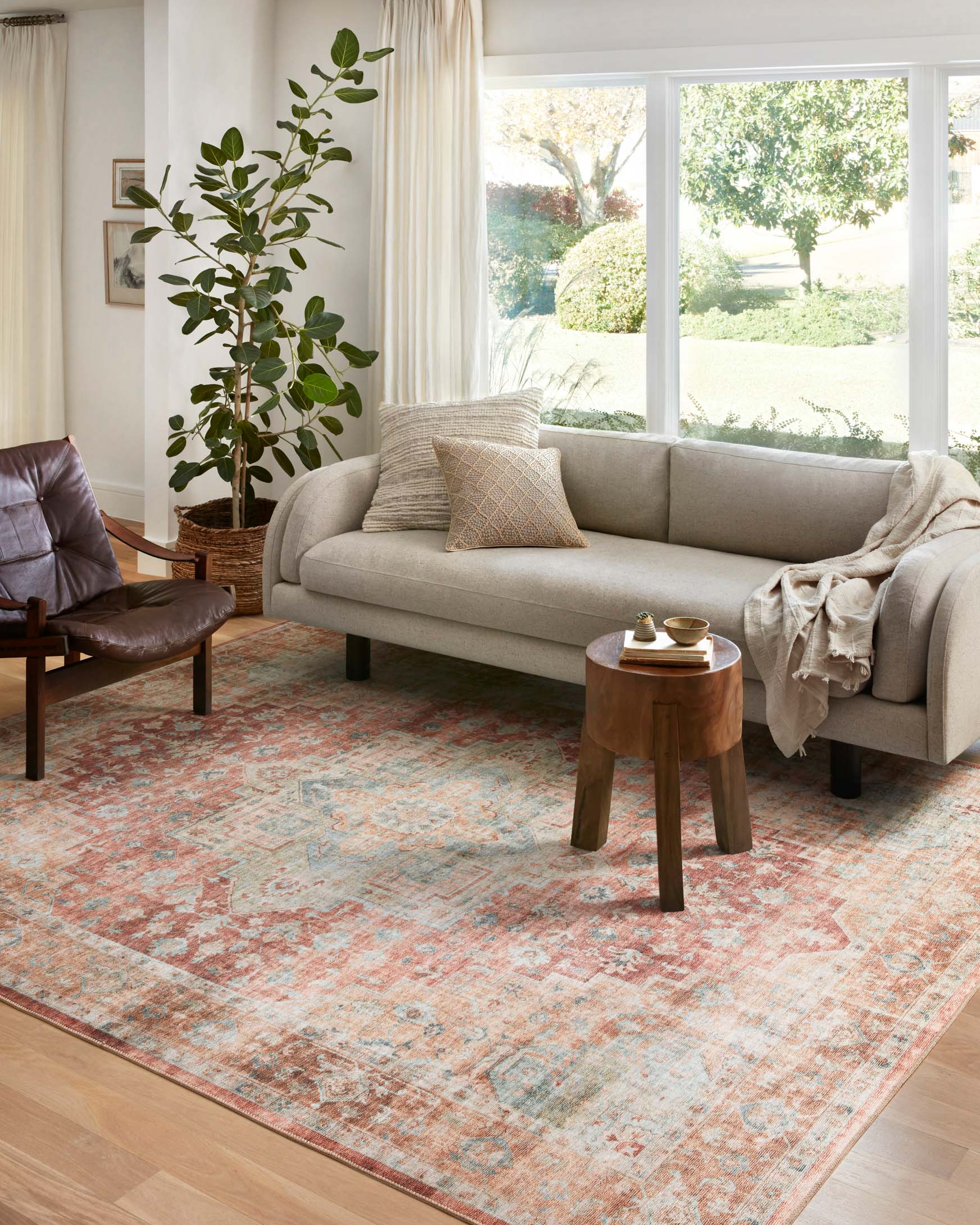 Traditional power-loomed area rug in terracotta and aqua with ornate center medallion.