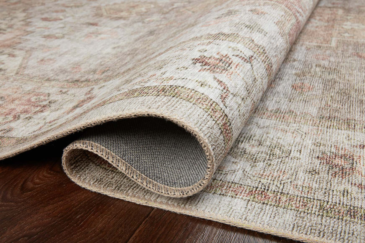 Traditional power-loomed rug rolled edge showing textured low-pile surface and woven backing