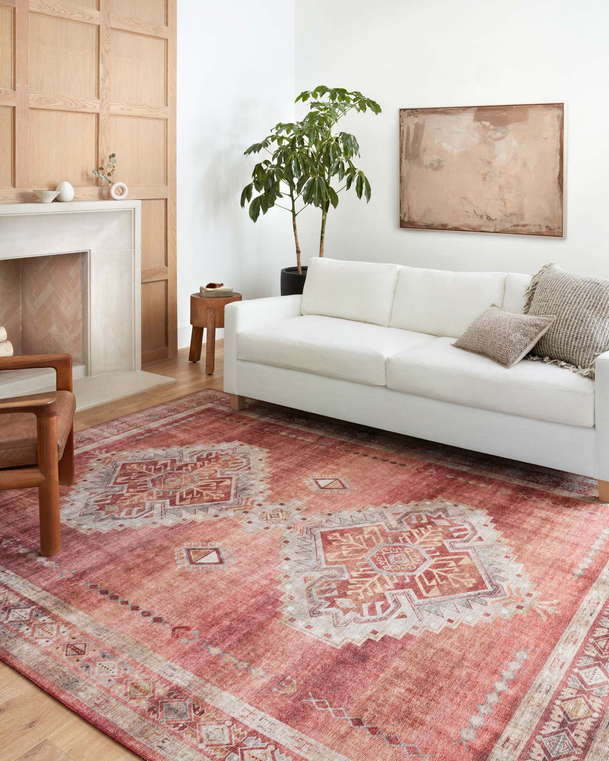 Rust red and ivory traditional rug with central diamond motifs and decorative border.