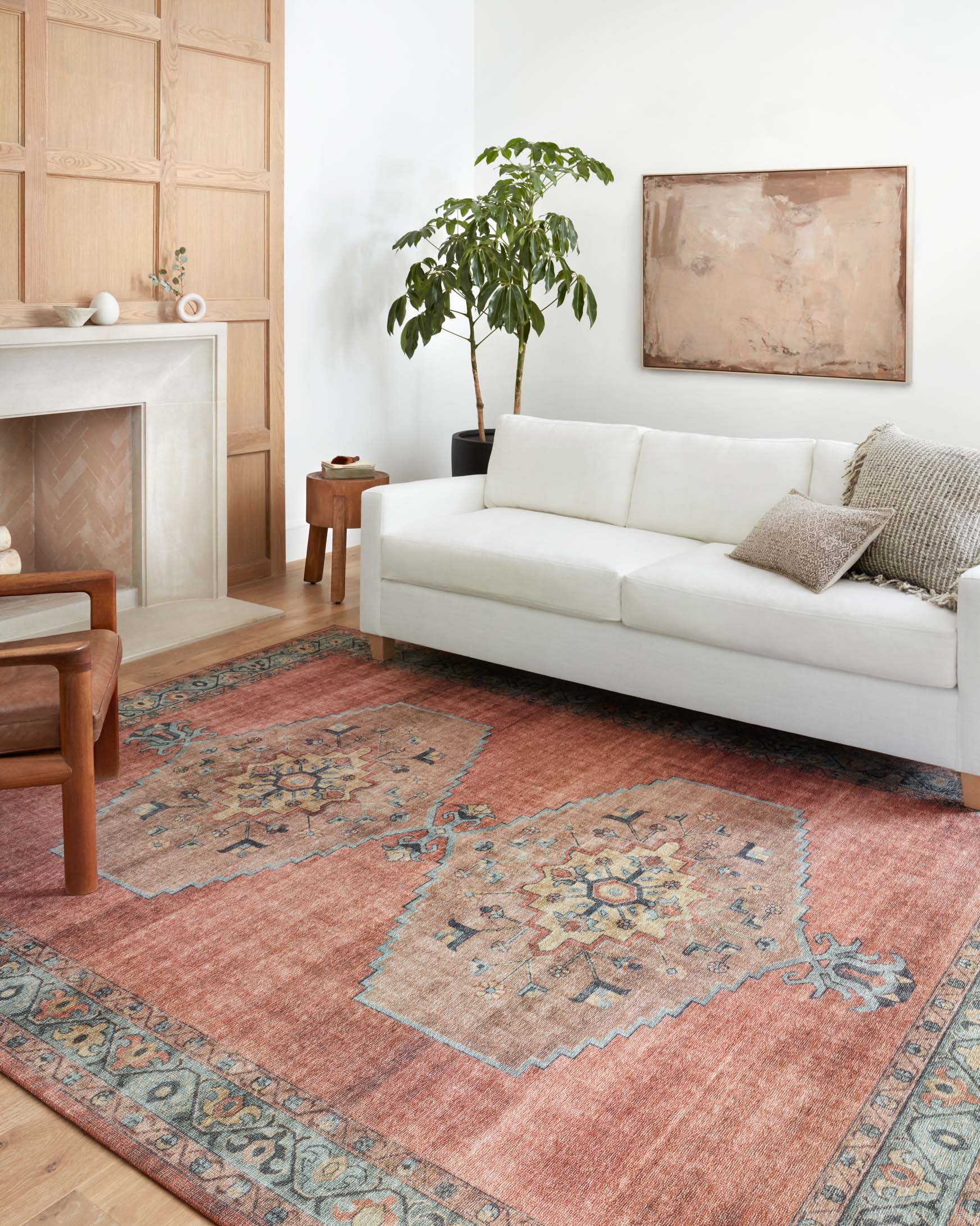 Traditional area rug with spice rust ground and aqua geometric medallion center