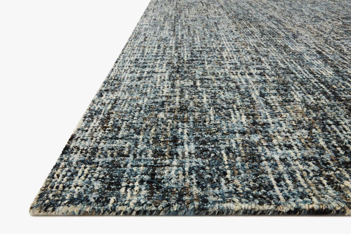 Denim-and-charcoal hand-tufted area rug angled view showing dense pile texture