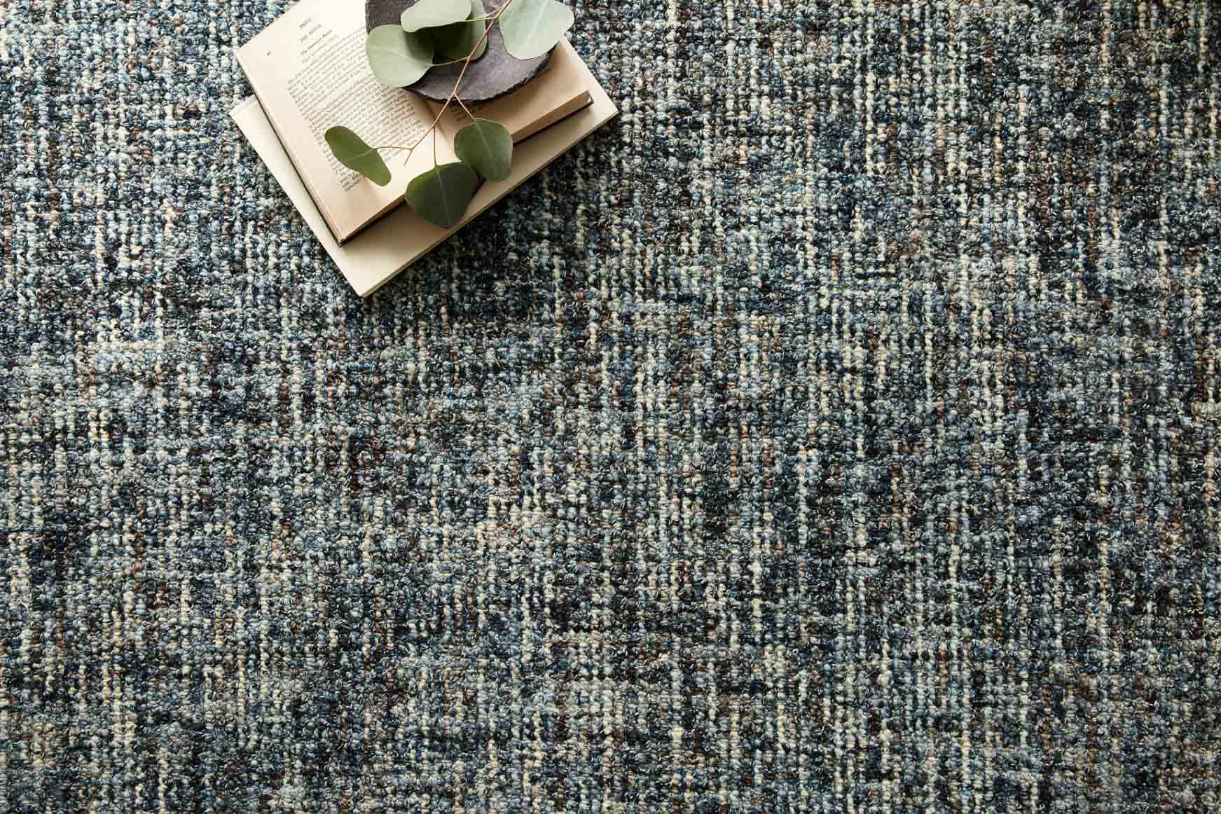 Denim-and-charcoal hand-tufted area rug close-up with speckled woven texture