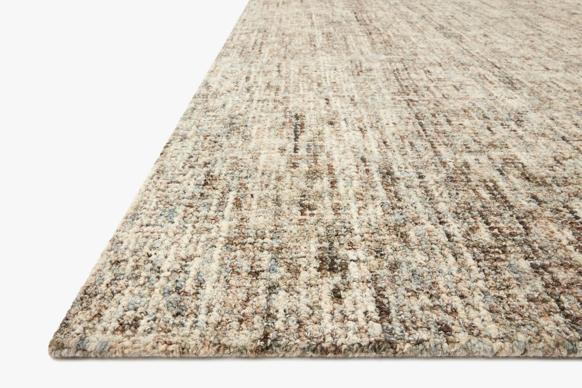 Rectangular hand-tufted rug in mist beige with mocha and taupe abstract lines.
