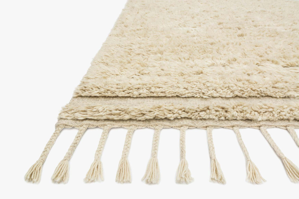 Oatmeal rug corner with off-white fringe and chunky hand-loomed texture