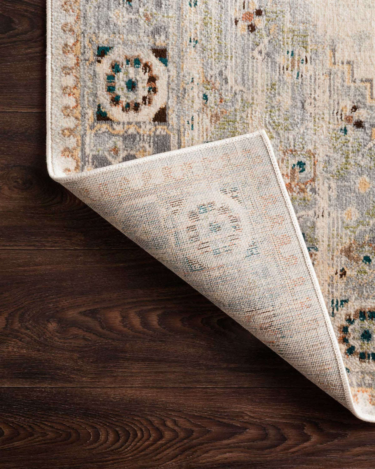 Oatmeal and silver rug showing woven backing texture on a rolled corner