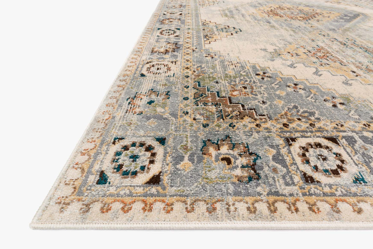Oatmeal and silver rug border with distressed geometric medallion motifs along the edge