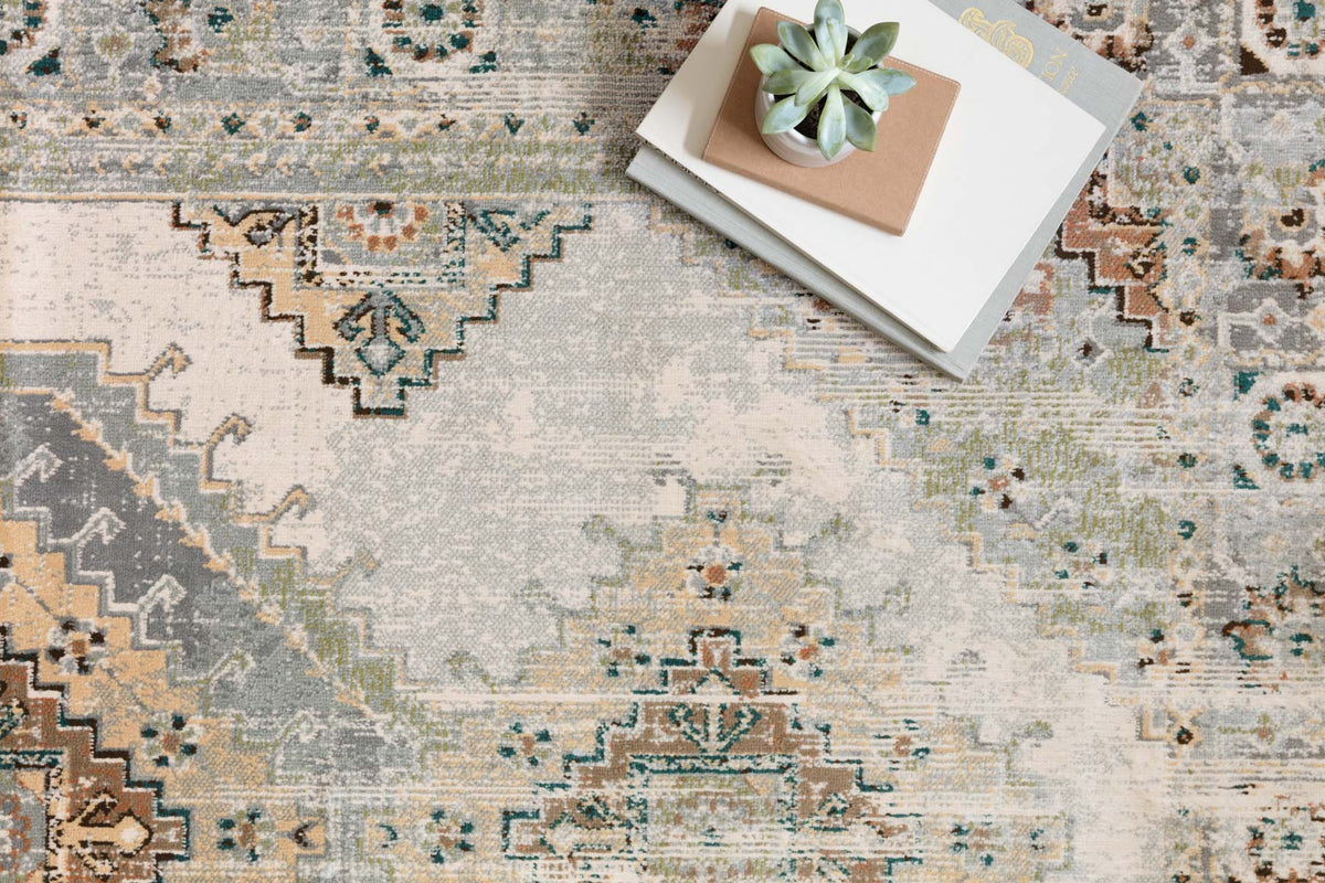 Close-up of oatmeal and silver transitional rug with dotted, zigzag, and medallion details