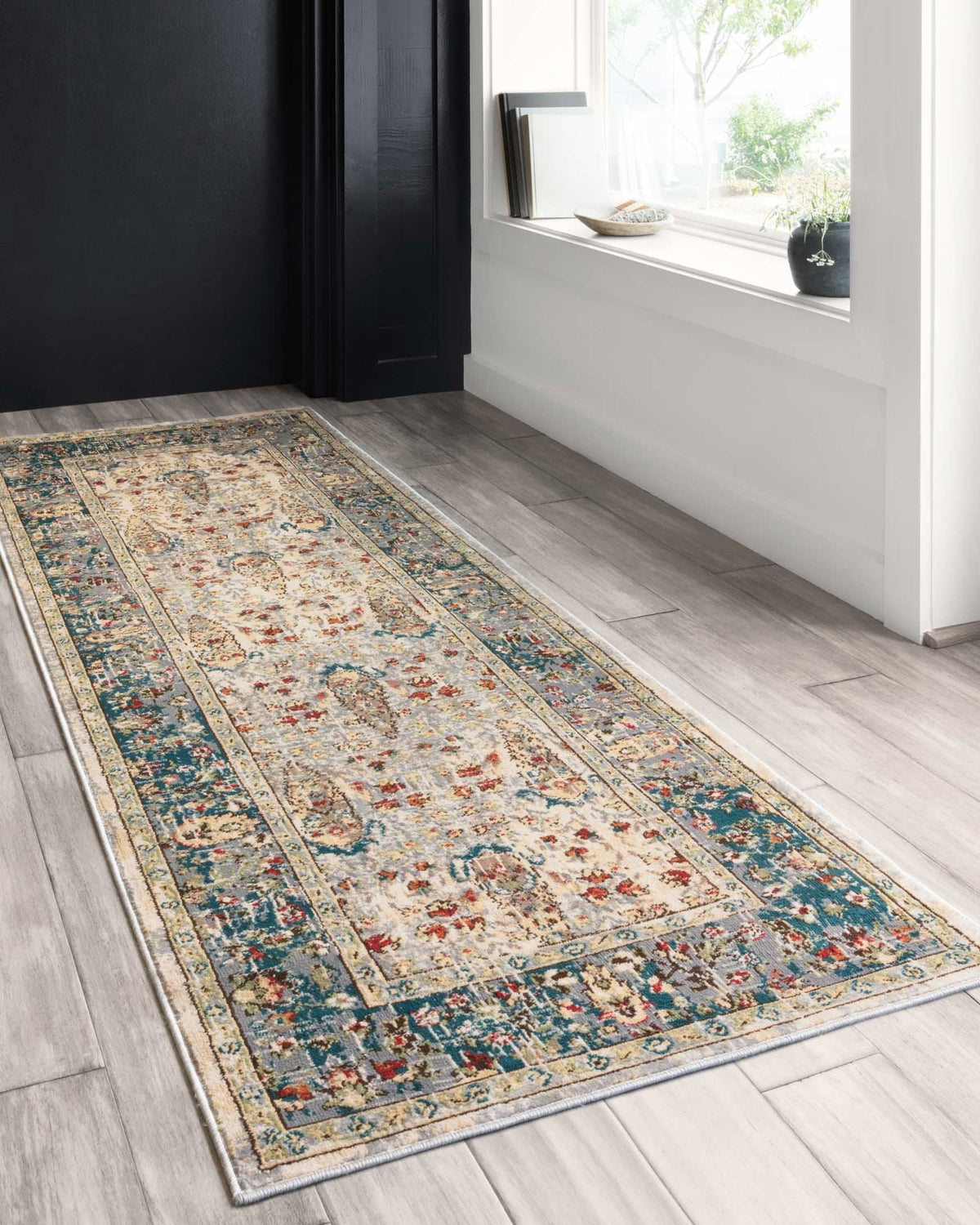 Rectangular transitional rug with sand ivory background, teal and red detailing, decorative border.