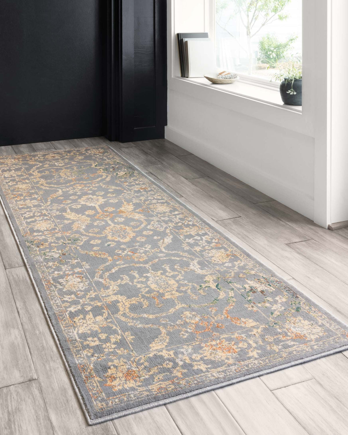 Transitional power-loomed runner rug with gray base and gold-toned floral details