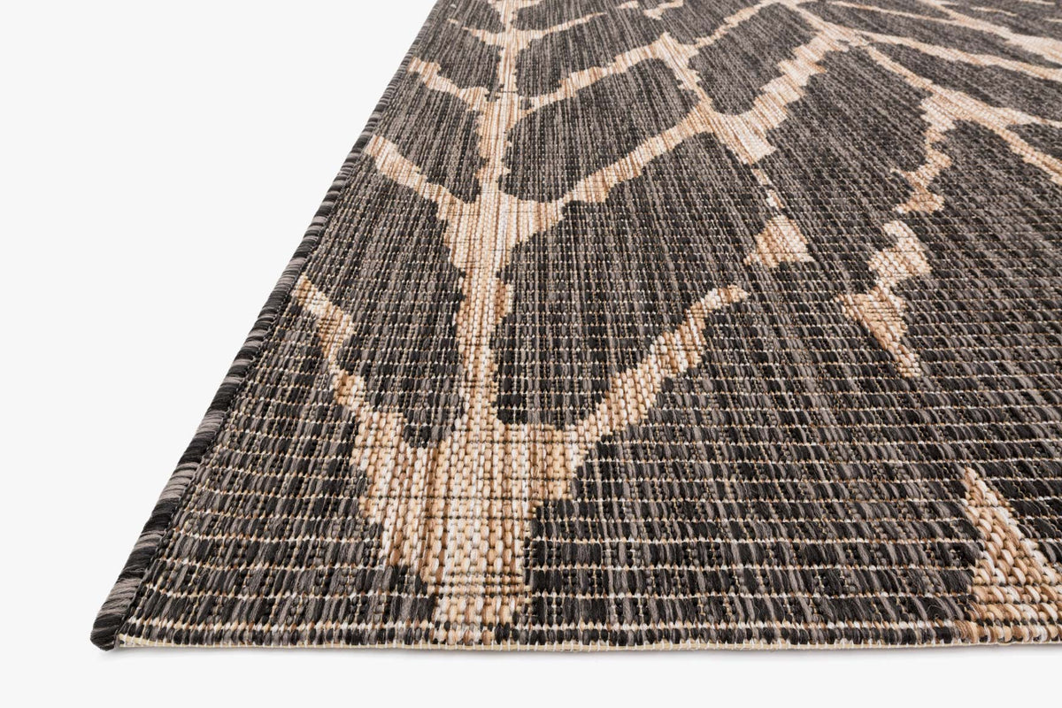 Charcoal indoor/outdoor rug corner with mocha chevron weave and bound edge