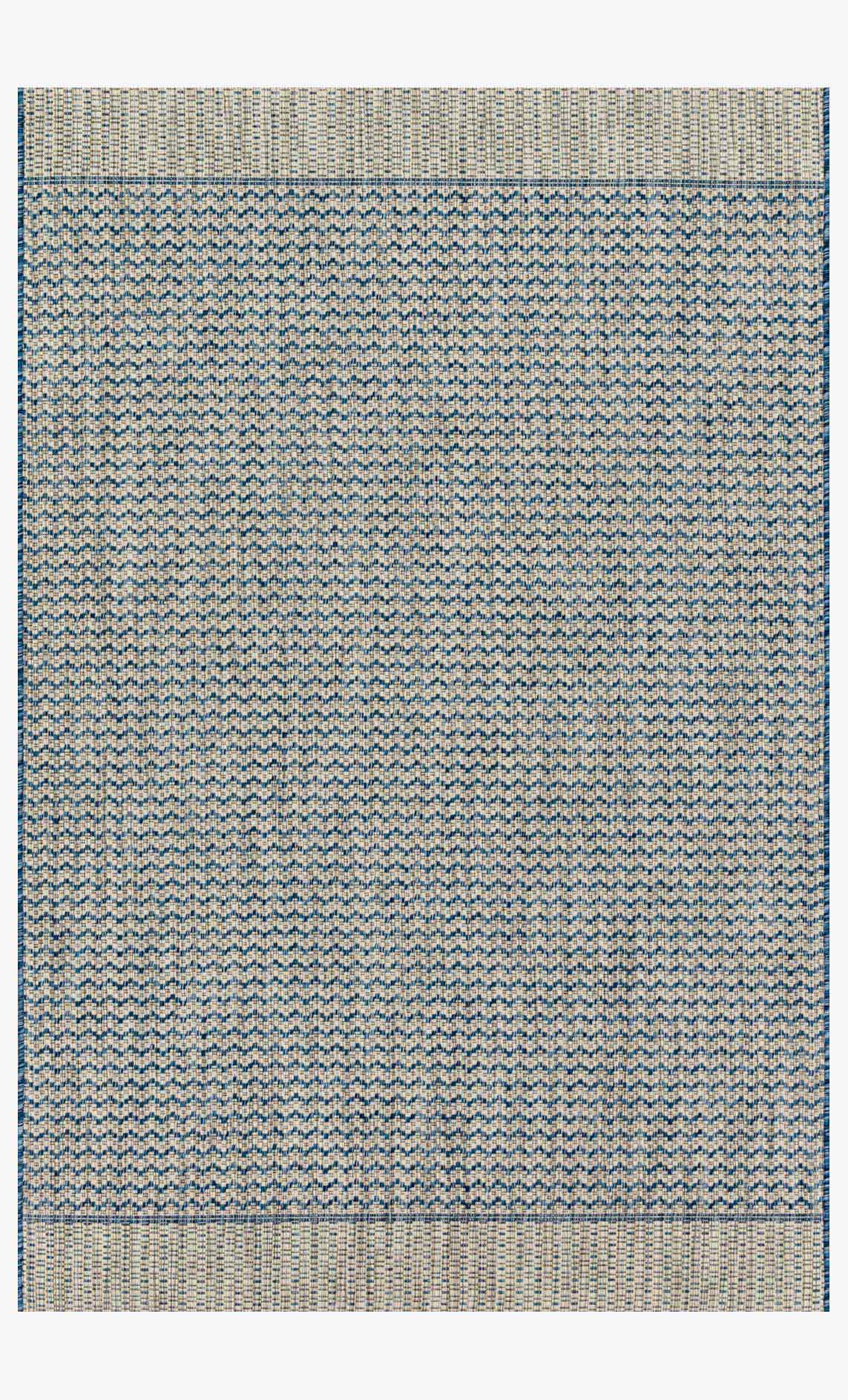 Grey and blue power-loom rug with repeating chevron pattern and border edges.