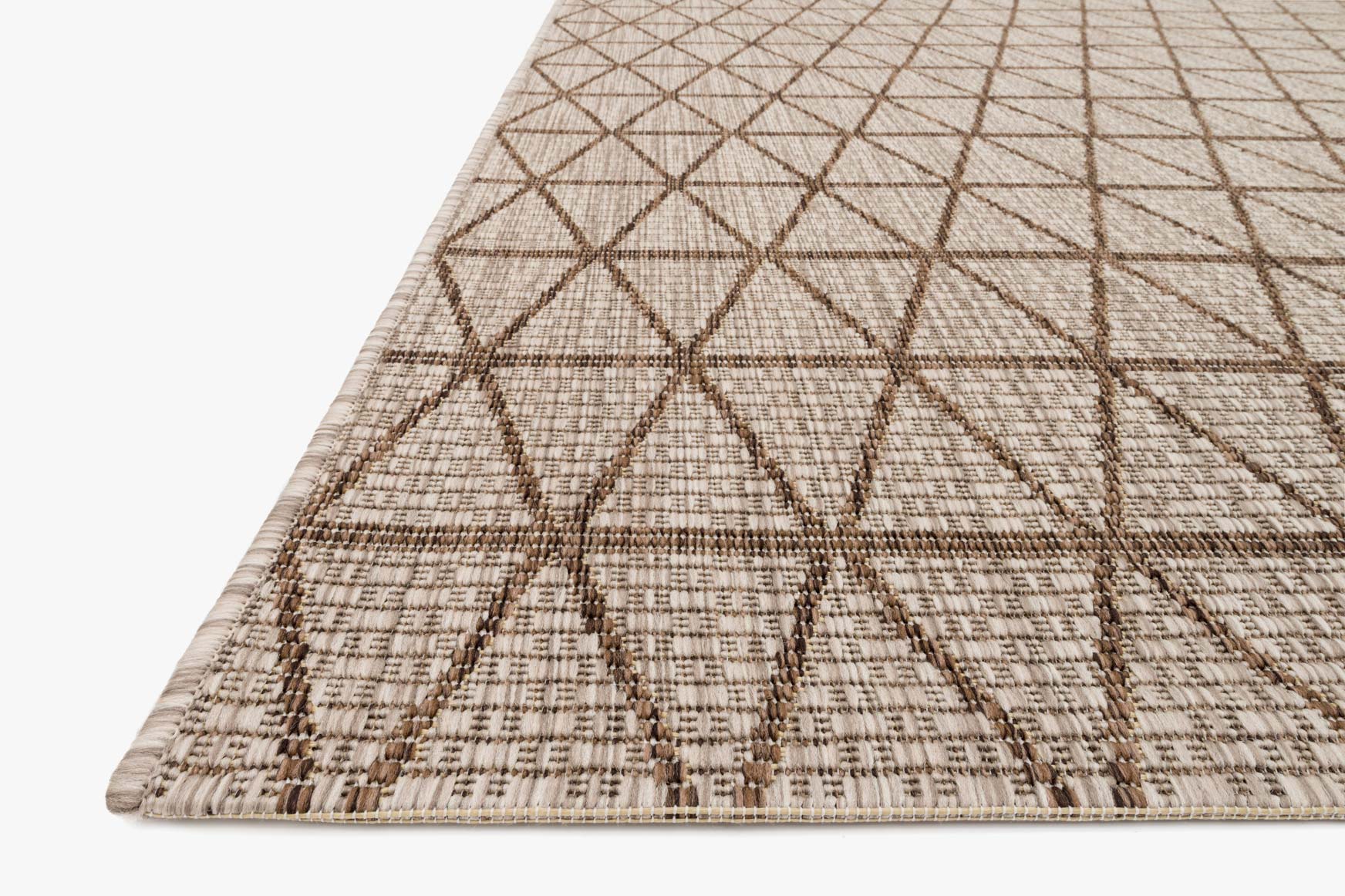 Beige and mocha geometric rug corner with diamond lattice and stripe details