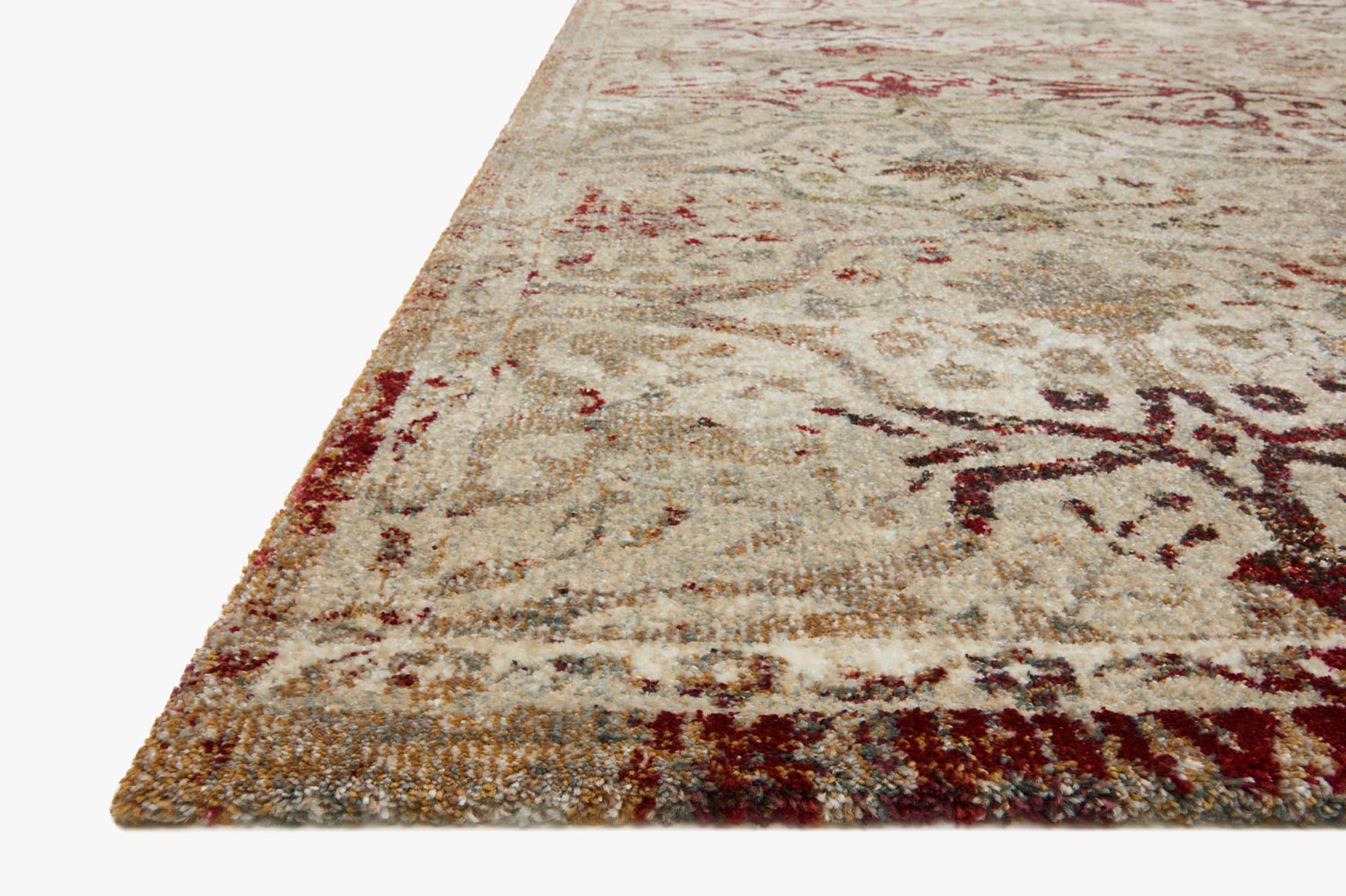 Cream and silver rug with burgundy ornamental motifs, angled view