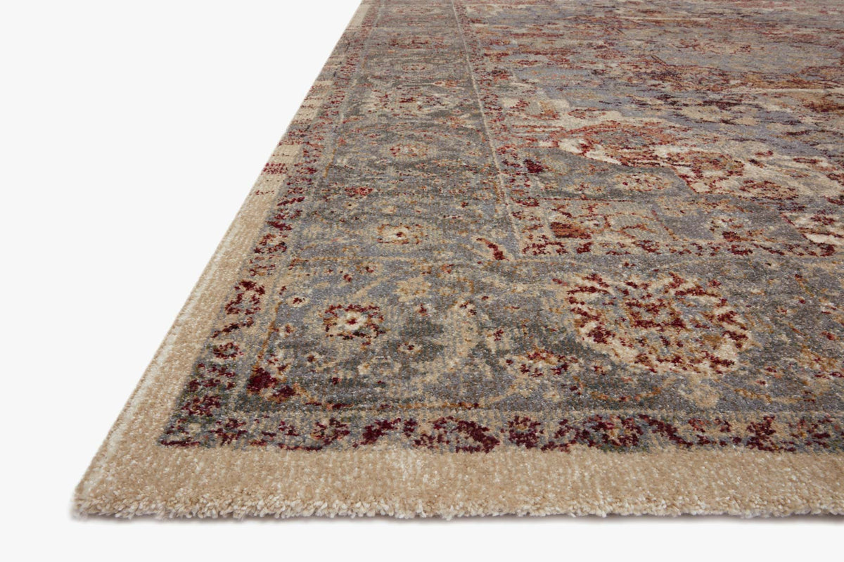 Slate blue rug with distressed brick-red medallion motifs and textured fringe edge