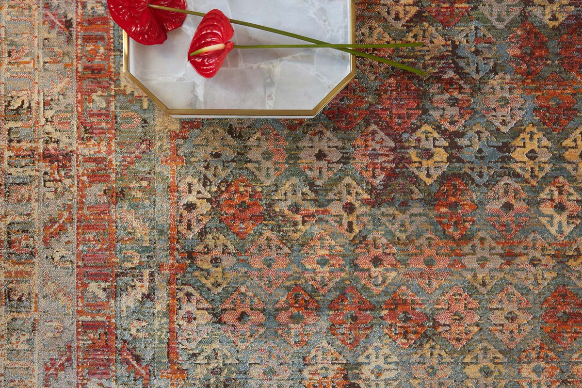 Close-up of contemporary power-loomed rug pattern in slate and berry with red accents