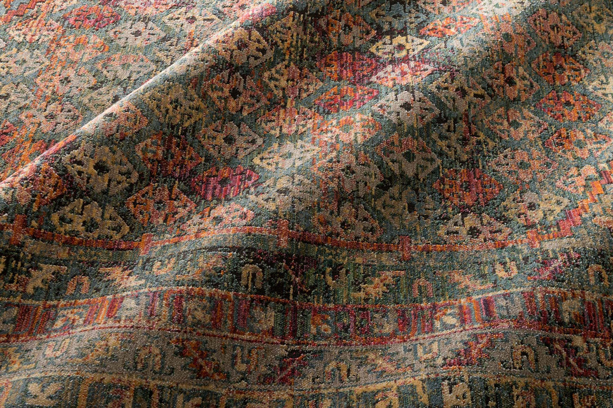 Contemporary rug surface with dense multicolor yarn texture in slate and berry