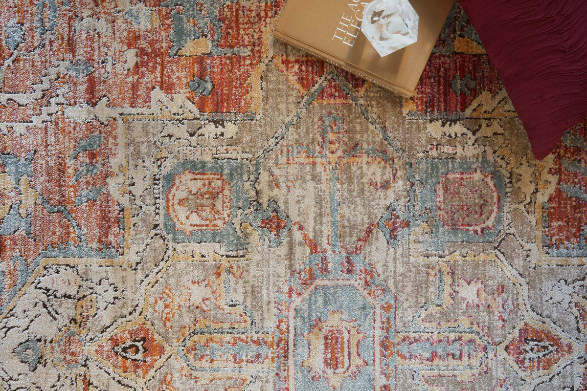 Power-loomed rug close-up with ornate blocks and speckled texture in beige, blue, and red