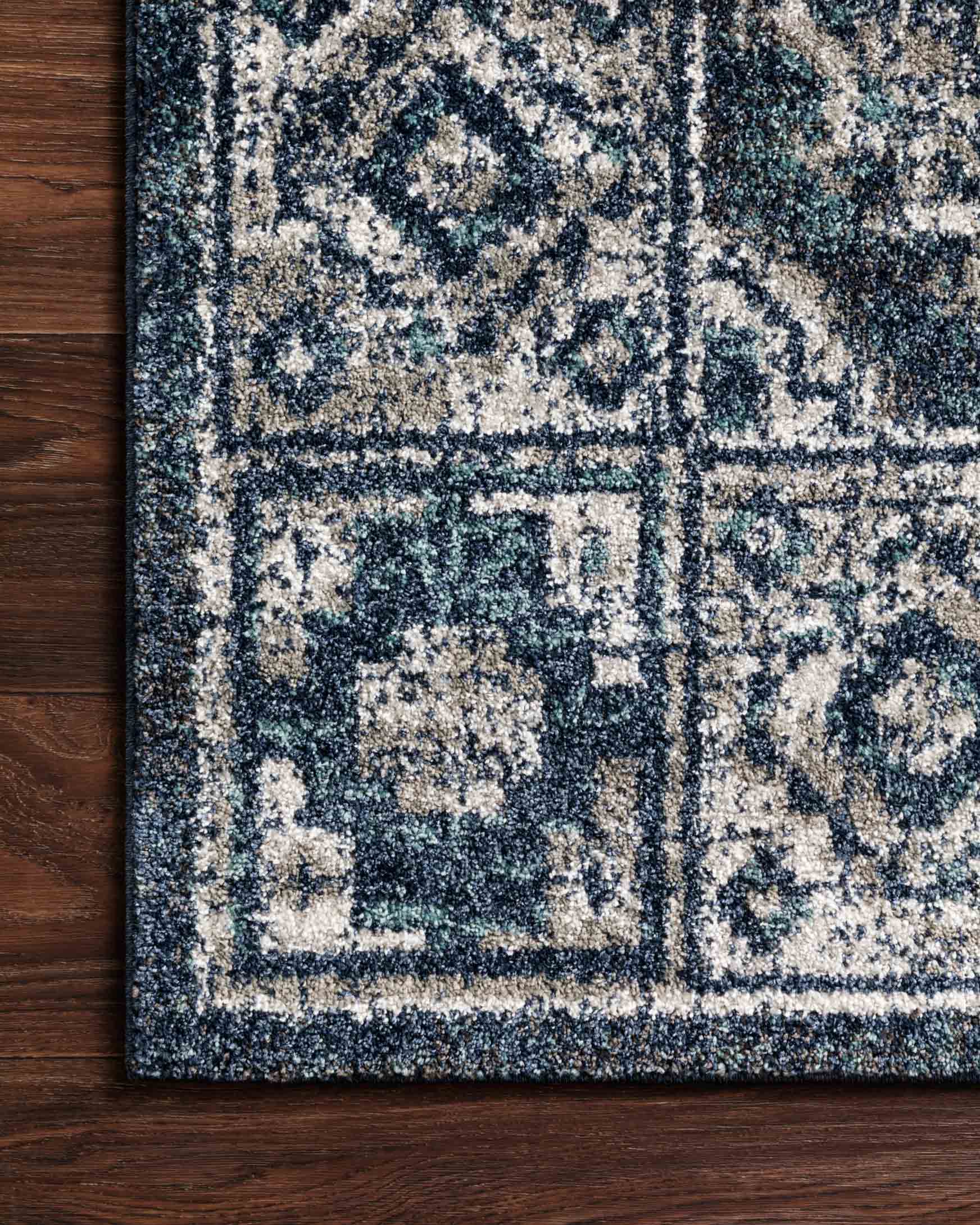 Traditional power-loomed rug close-up of textured geometric pattern, denim blue and grey