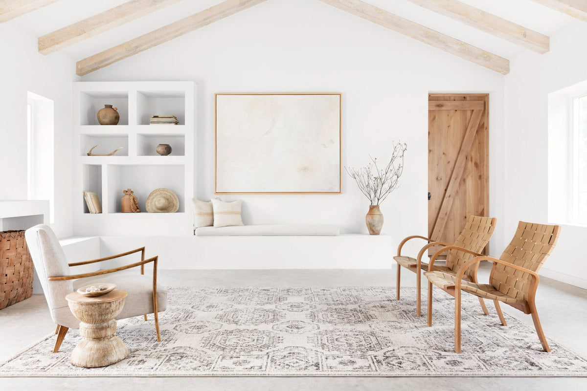 Ivory and charcoal traditional area rug displayed in a living room with geometric pattern