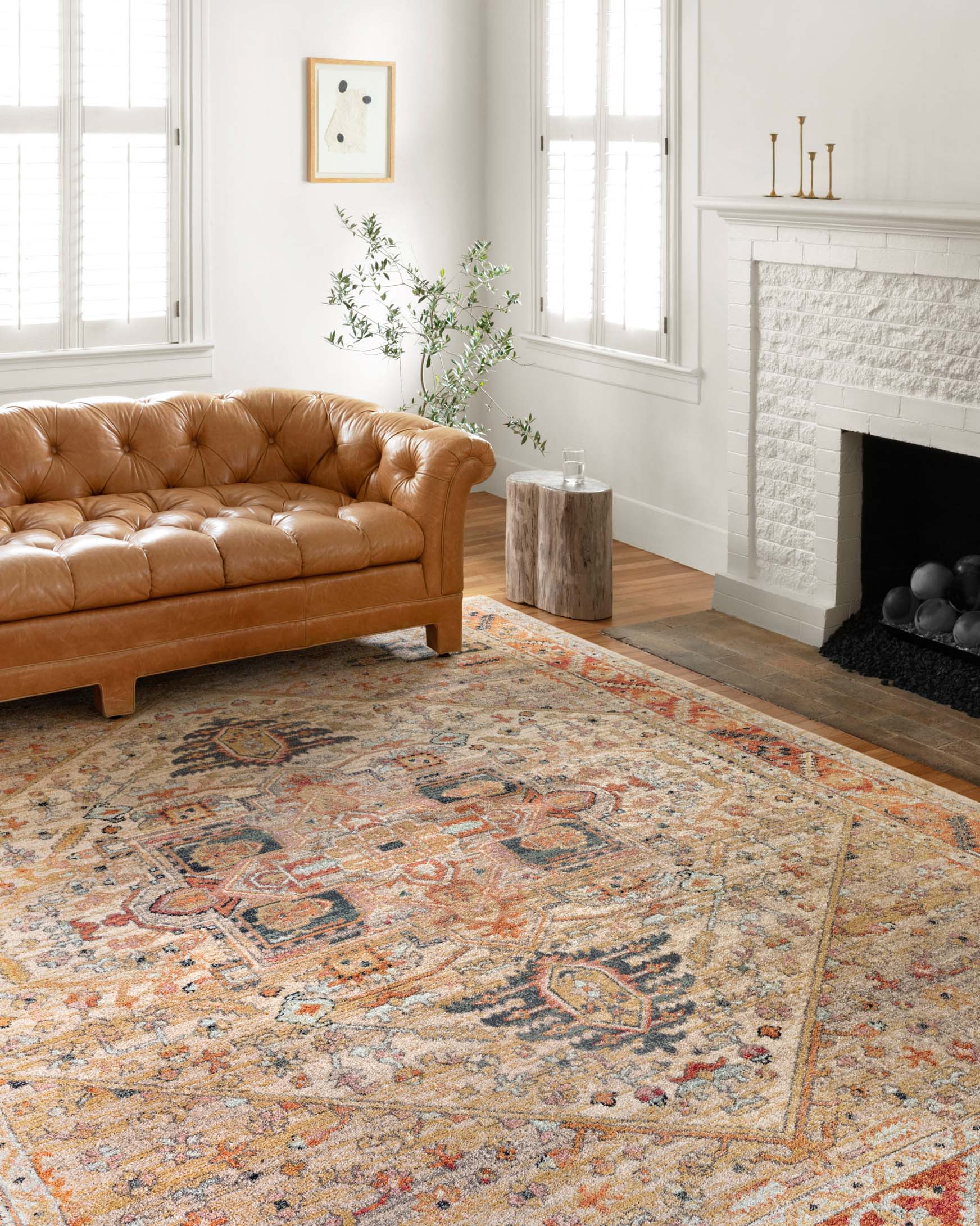 Transitional area rug with vintage-inspired medallion design in sand, rust, and blue tones