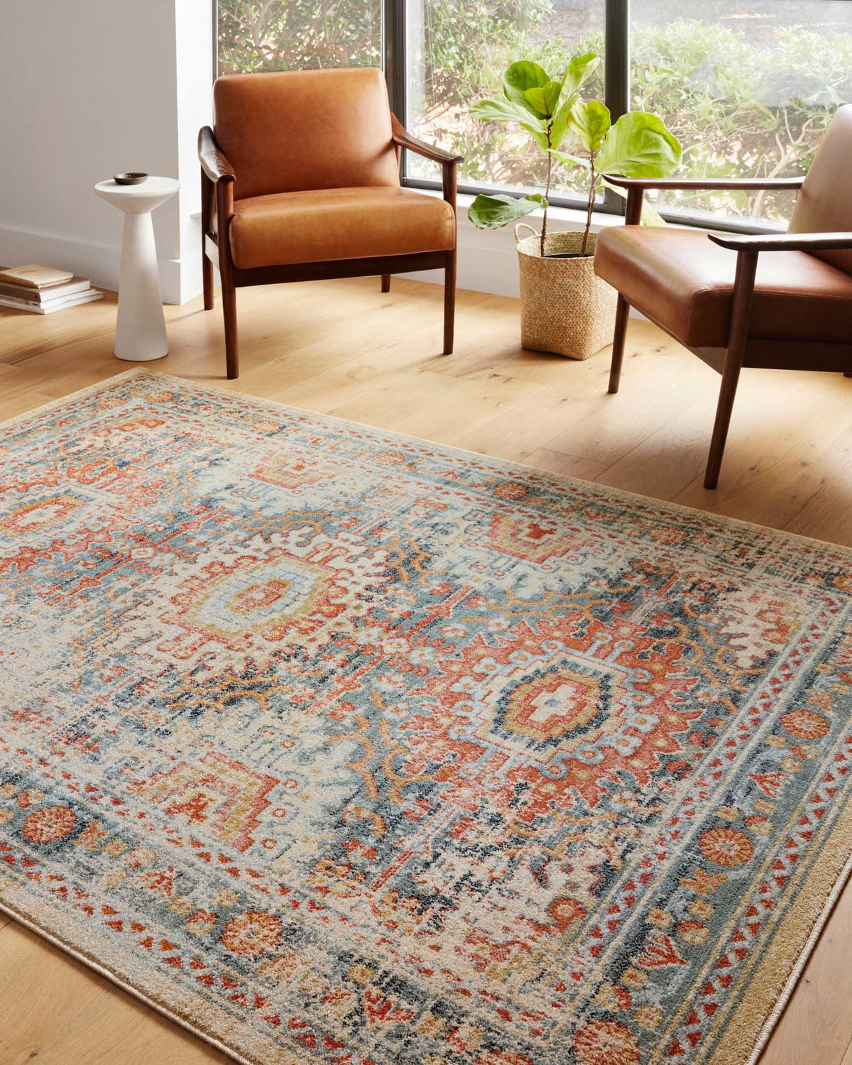 Transitional power loomed area rug, mist blue ground with orange and cream motifs