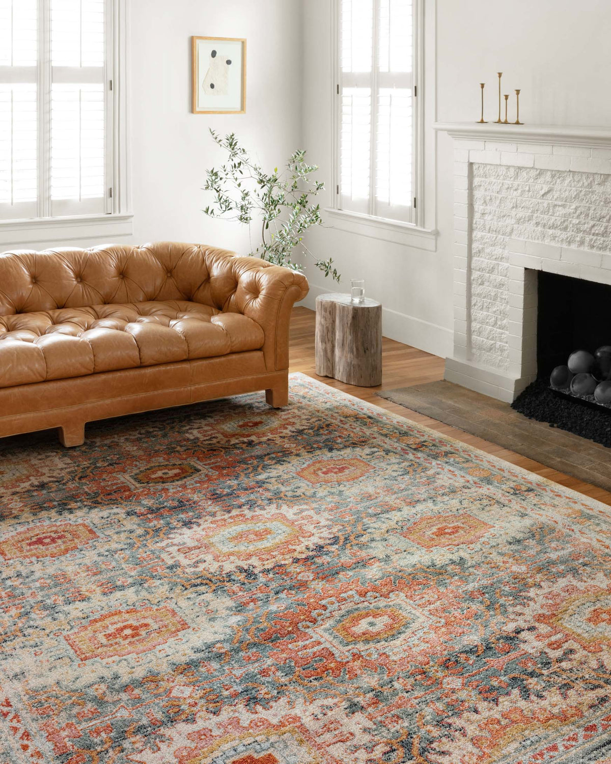 Transitional power loomed rug featuring distressed medallions in mist blue with orange accents