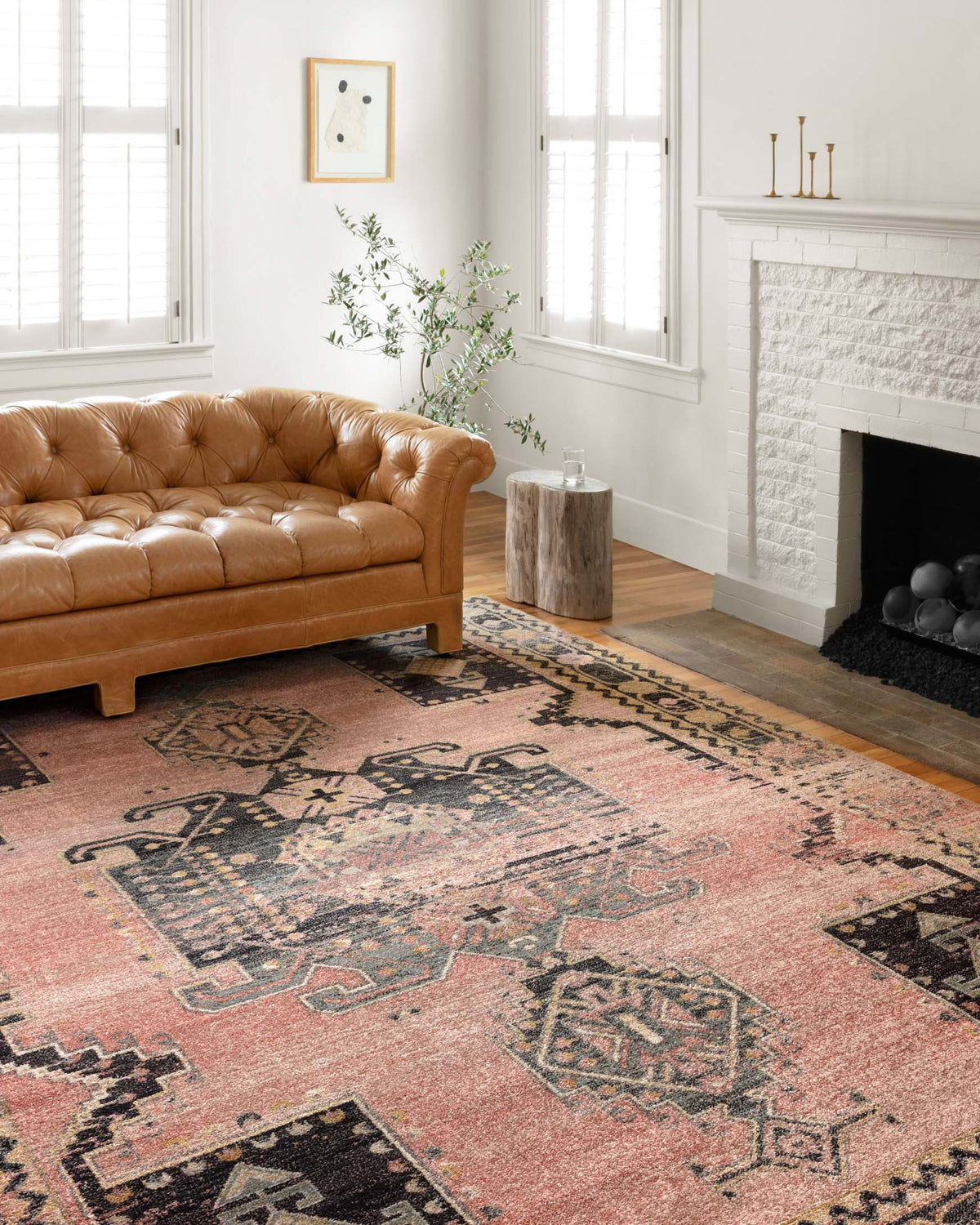 Transitional power-loomed rug laid on floor, rose pink and navy distressed pattern.