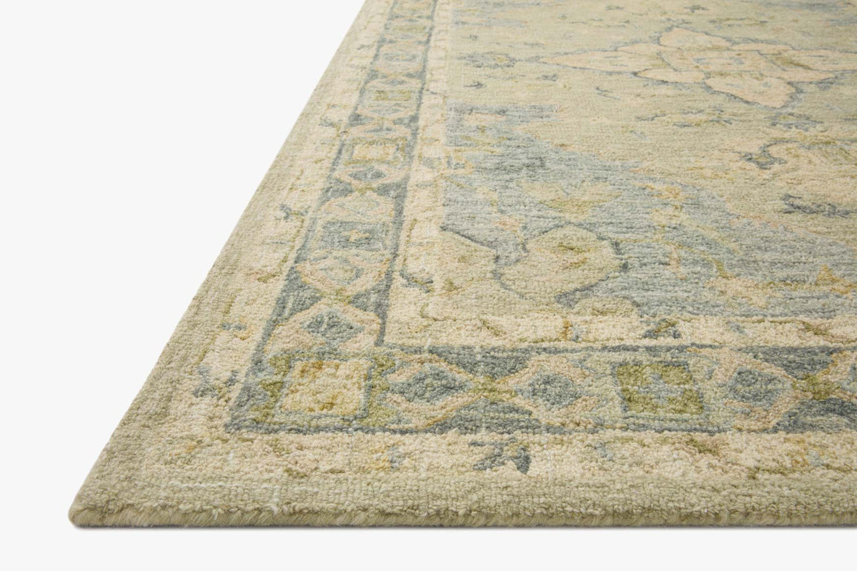 Corner view of seafoam green transitional hooked rug with flat woven border edge