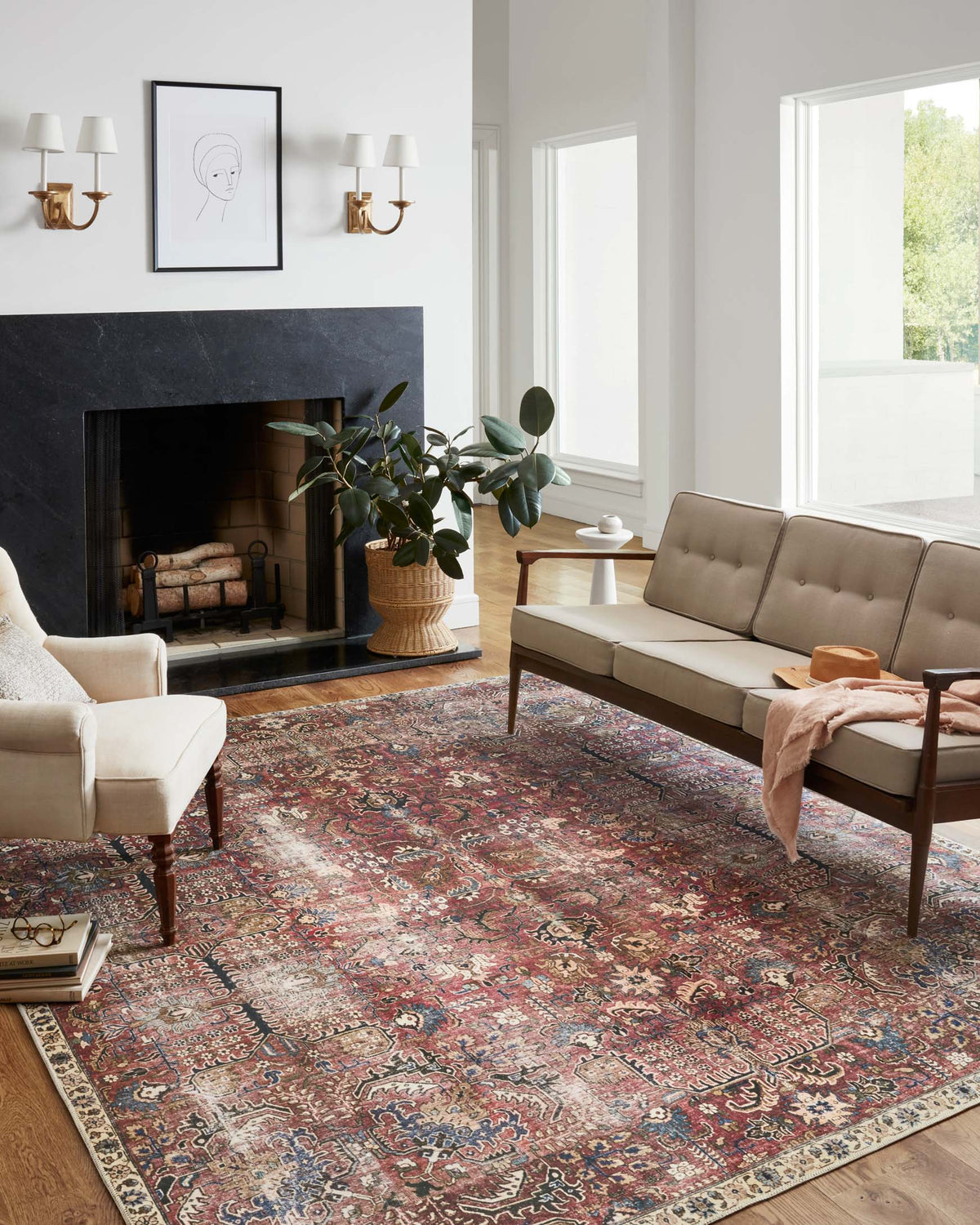 Large ornate rug featuring red, blue, and cream scrolling medallions and borders