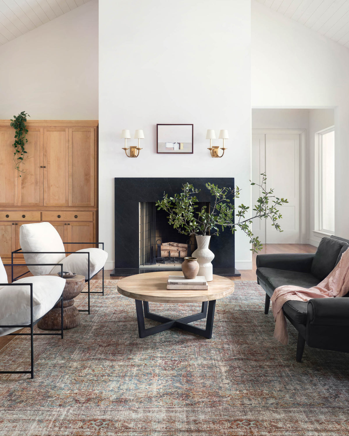 Large area rug with vintage-style teal and brick-toned pattern