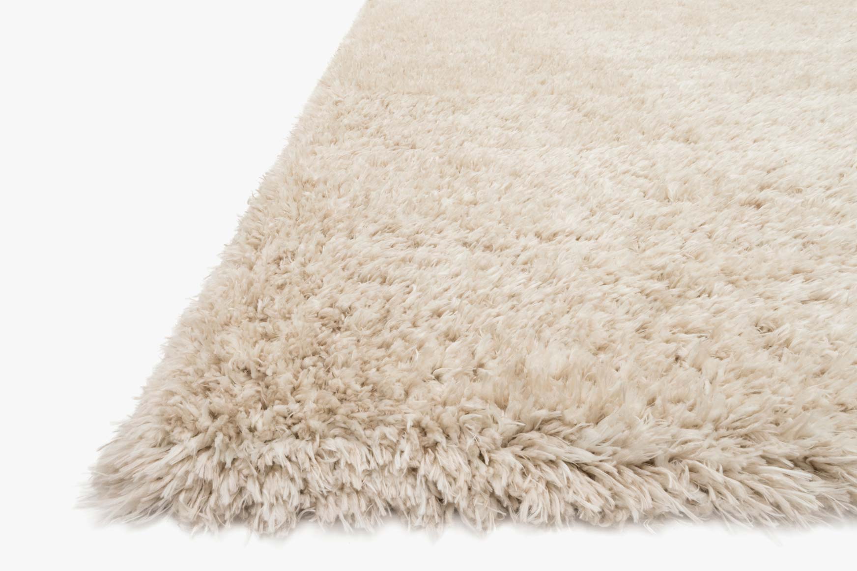 Beige shag rug corner close-up with soft, thick fibers