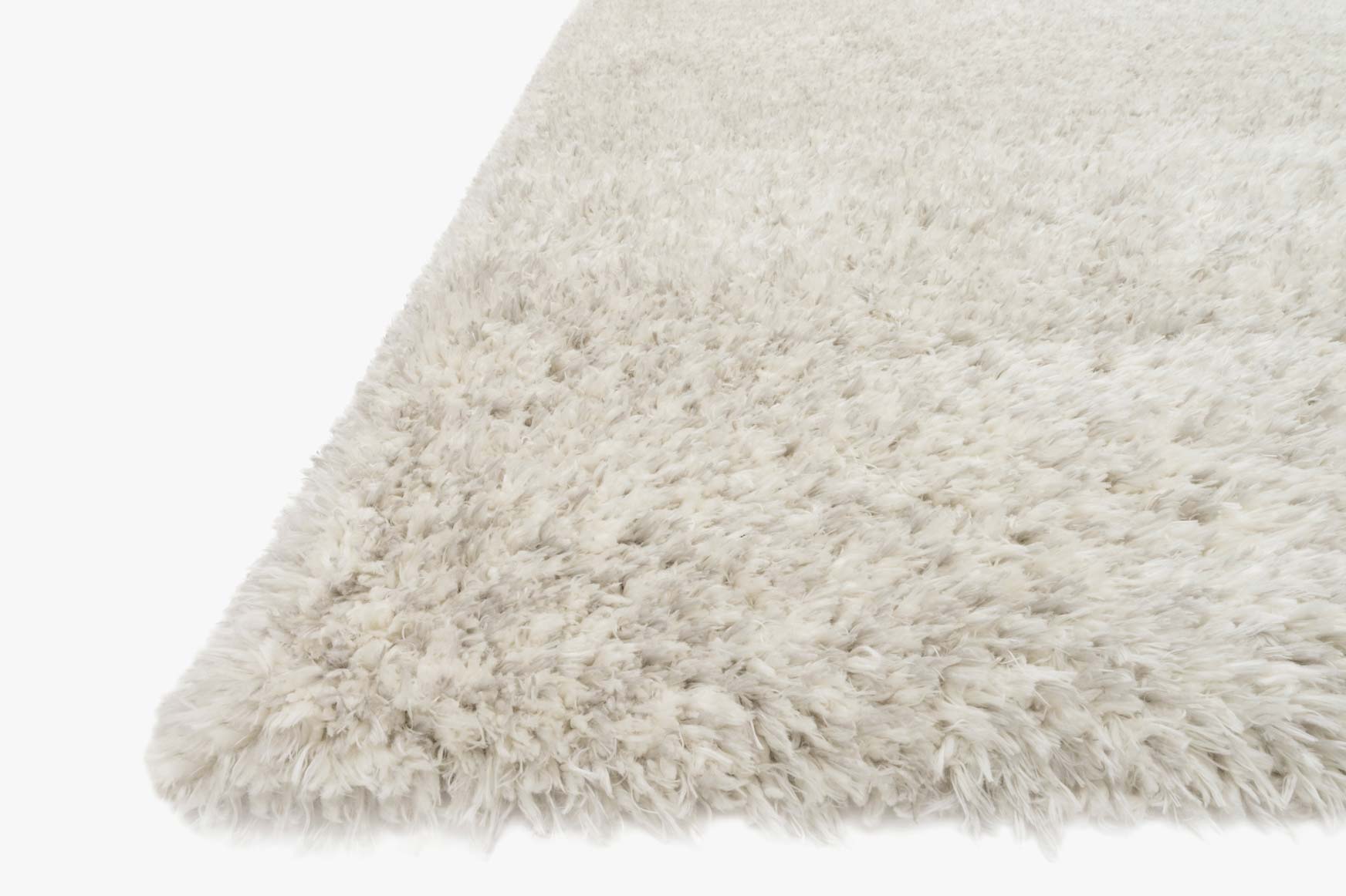 Light grey shag rug with thick low pile and rounded corner detail