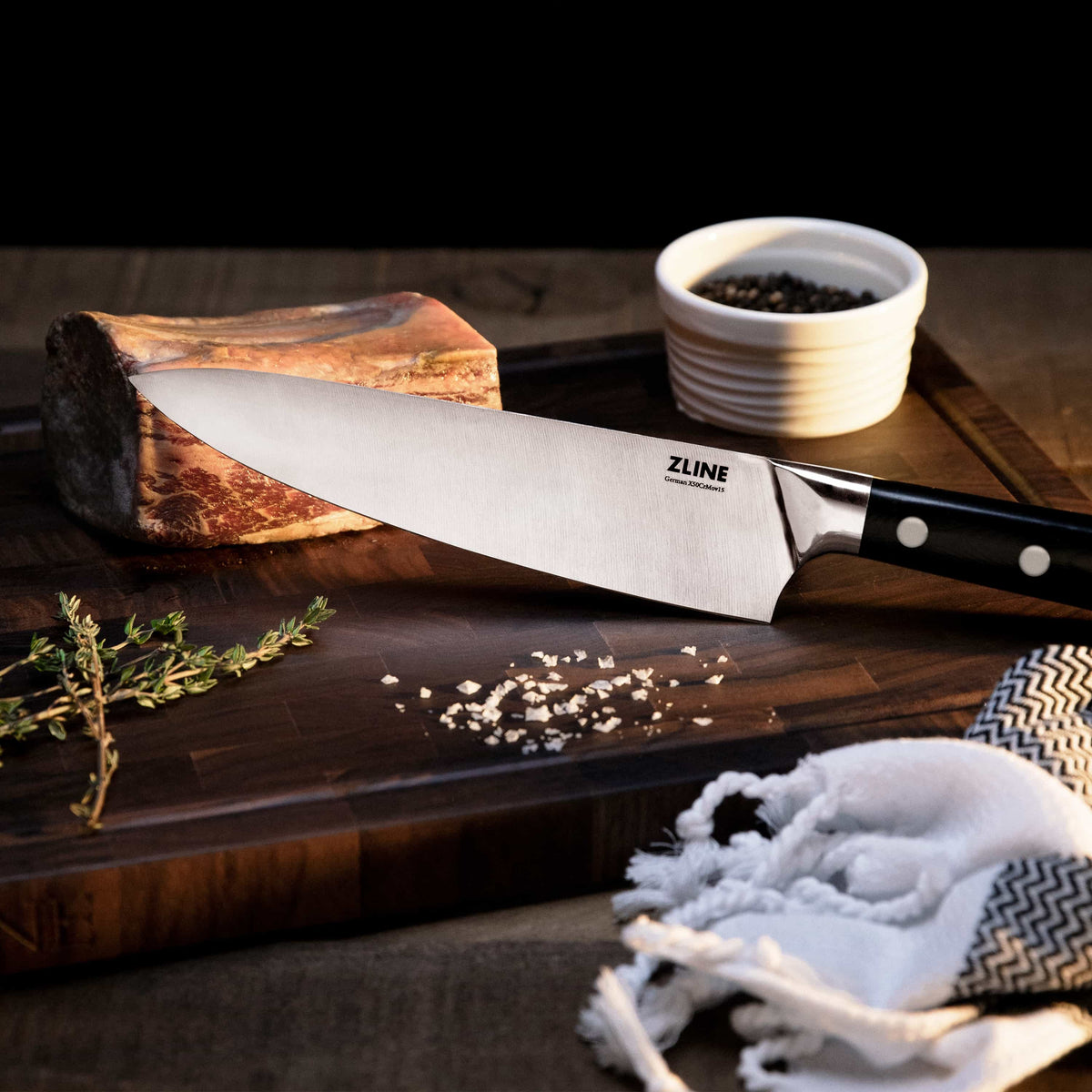 Chef’s knife close-up on cutting board, stainless blade and black dotted handle