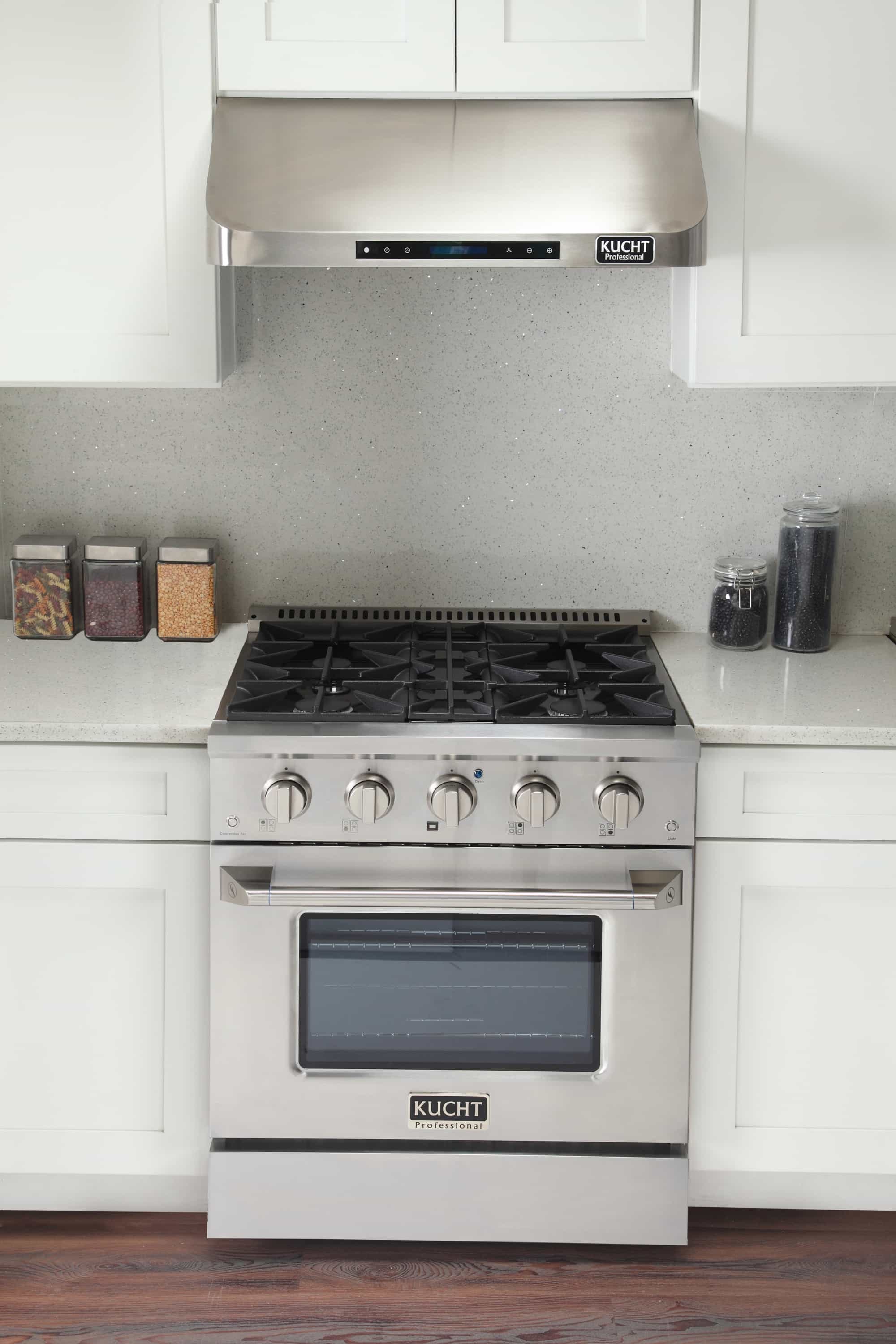 Stainless steel dual fuel range with gas cooktop and oven door in kitchen