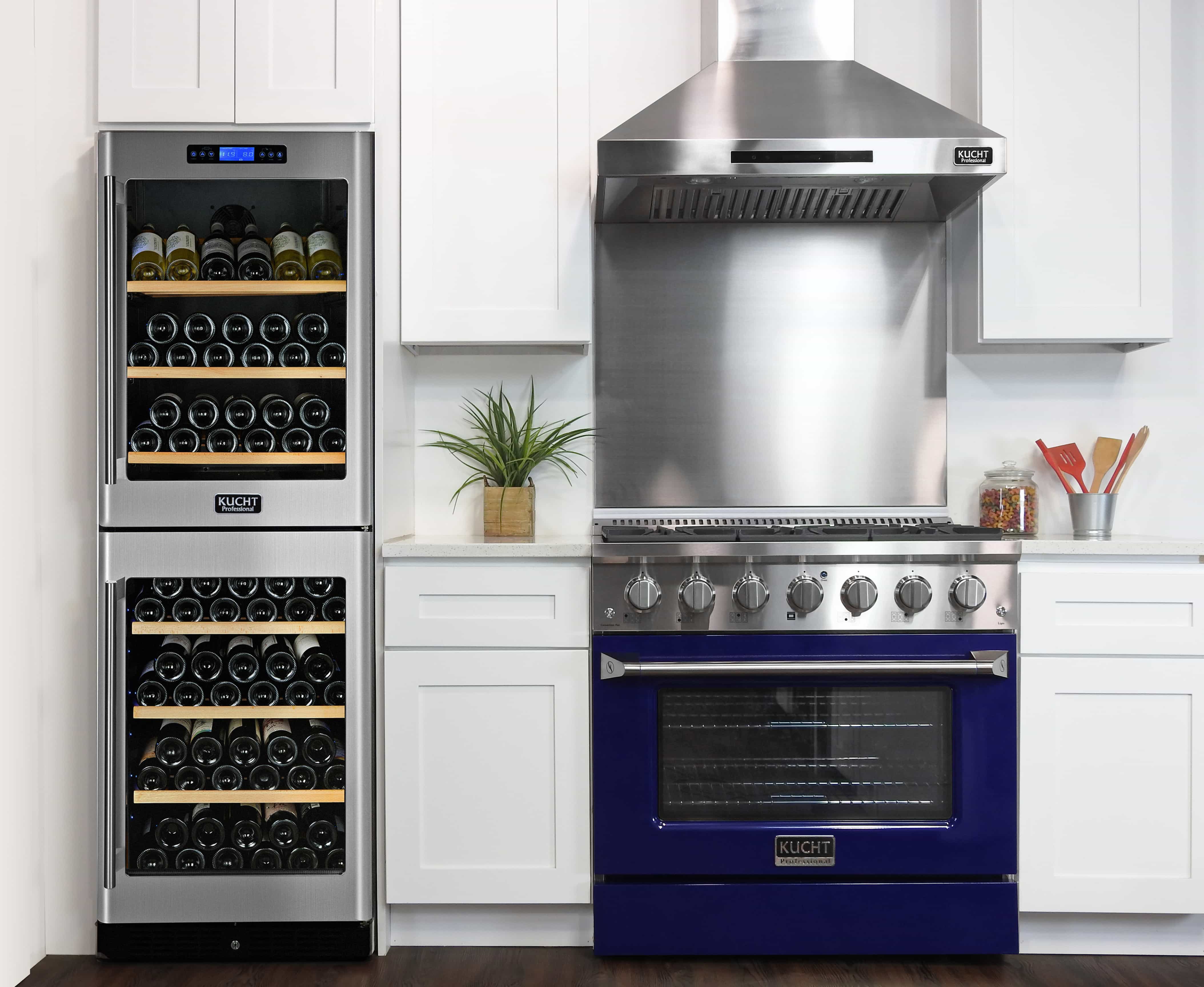 Freestanding stainless dual fuel range with blue oven door and stainless hood above