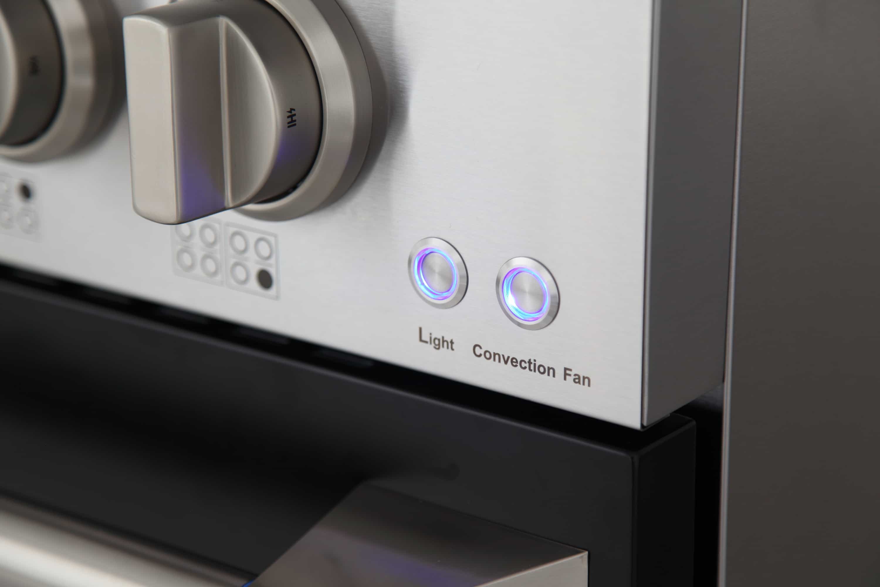 Dual fuel range control panel with knob dials and Light/Convection Fan indicators