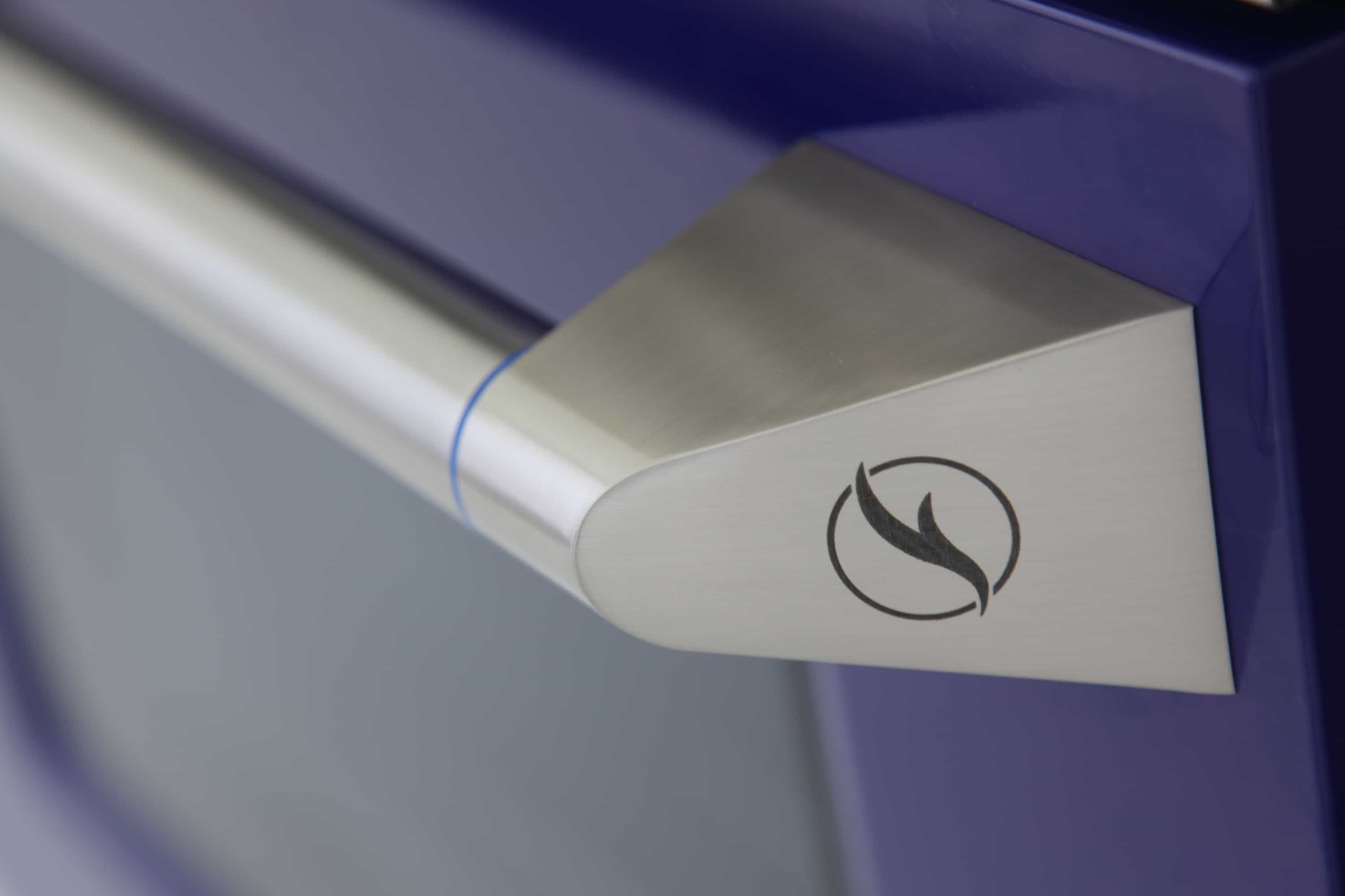 Stainless steel oven door handle with flame emblem