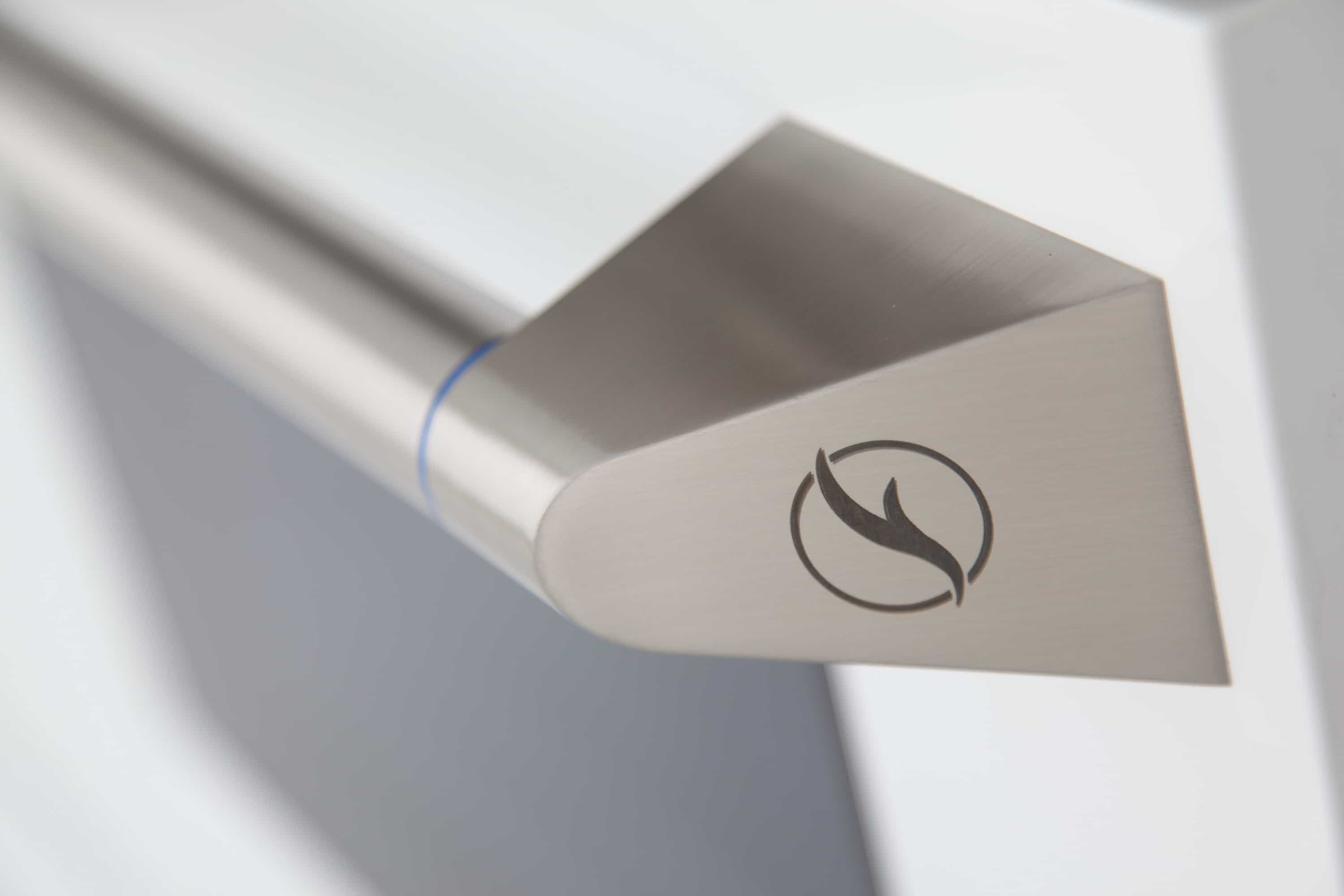 Stainless oven door handle with flame icon and blue accent ring