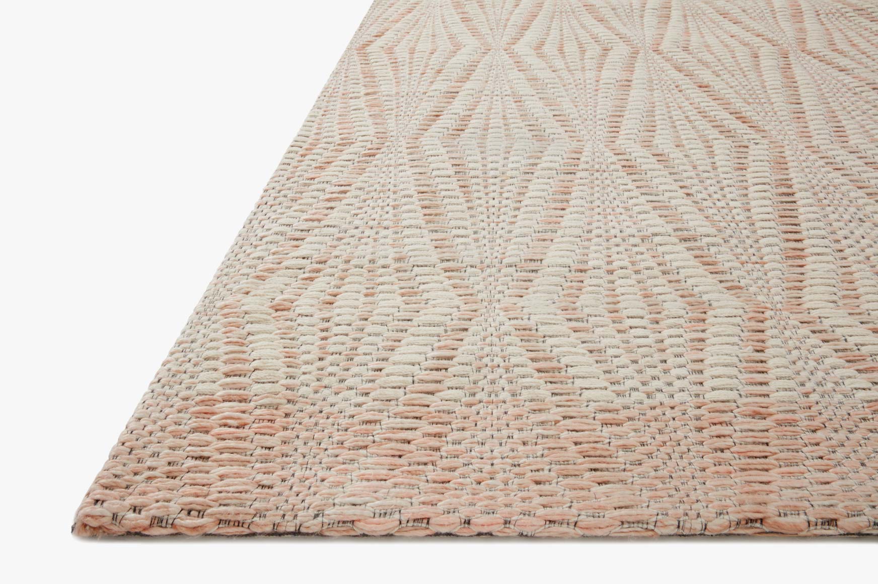 Ivory and blush corner of hand-woven rug with raised diamond weave and thin border