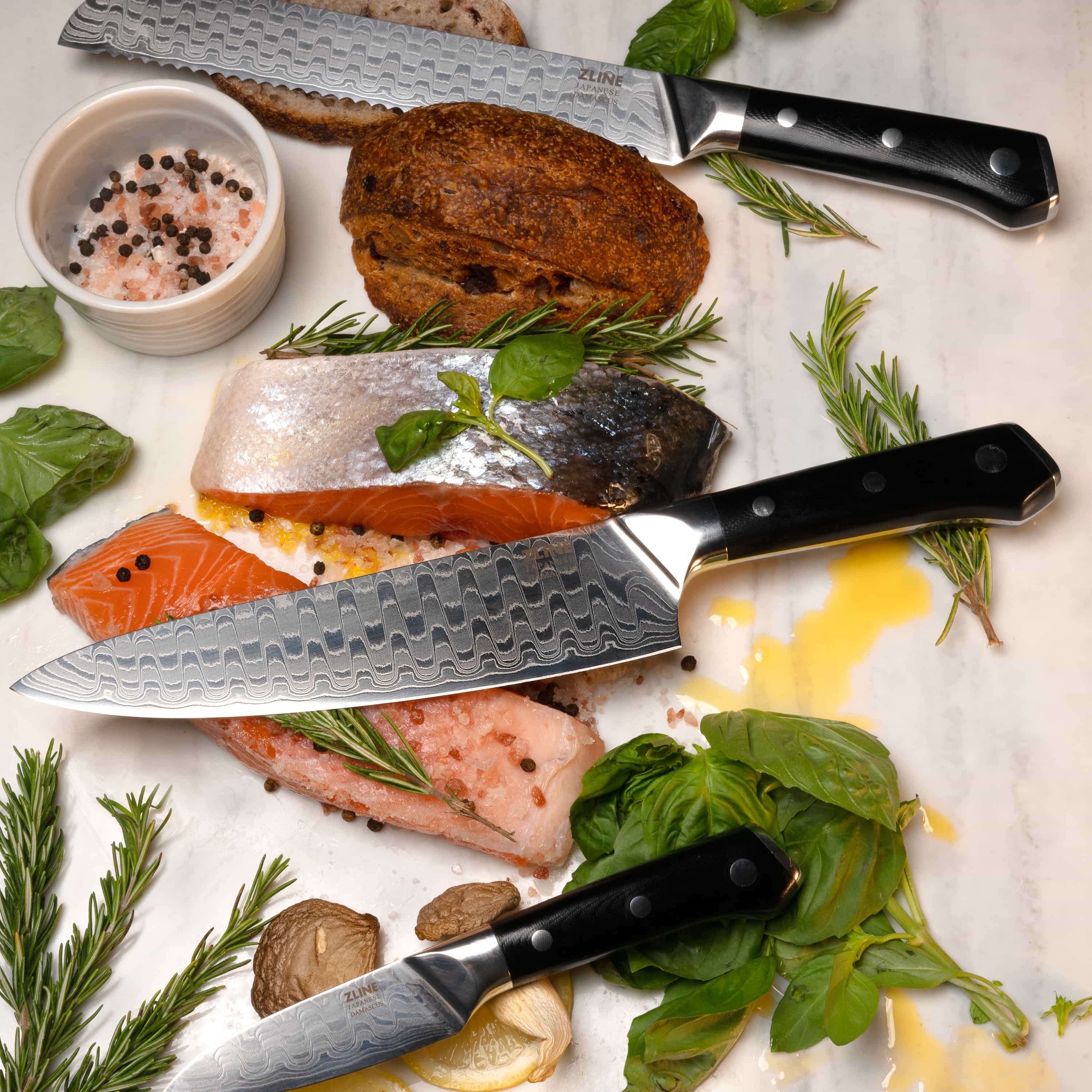 Three-piece knife set with Damascus blades and black handles with white dot rivets