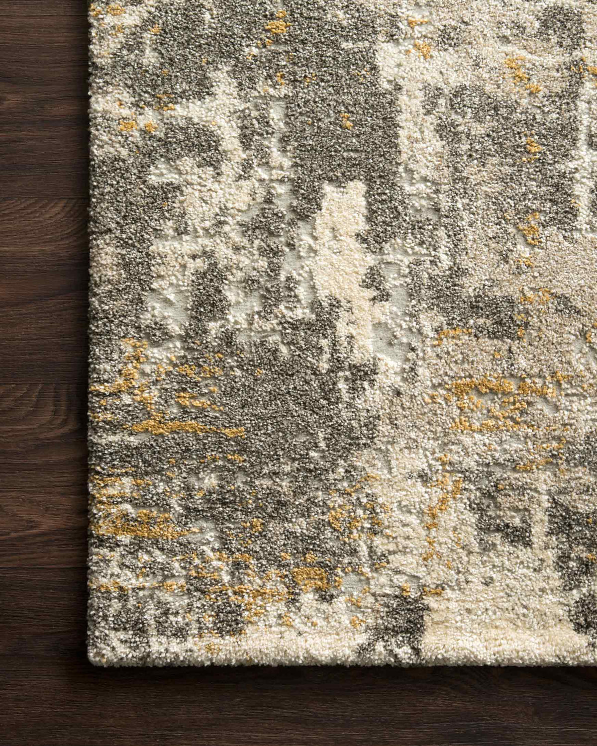 Close-up of contemporary power-loomed rug texture in gray, cream, and muted gold speckles
